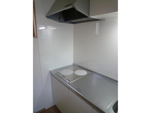 a small kitchen with white walls and a counter at Seaside Hostel Light House - Vacation STAY 82325v in Onomichi