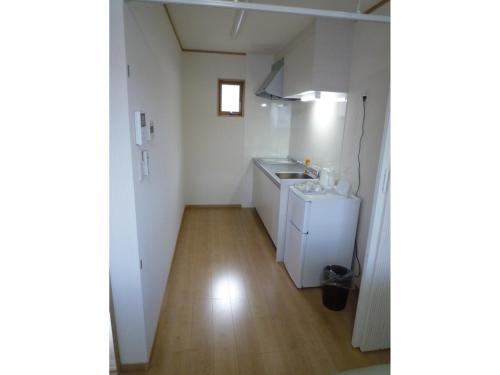a small white kitchen with a sink and a counter at Seaside Hostel Light House - Vacation STAY 82325v in Onomichi