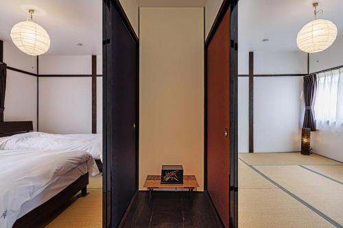 a bedroom with a mirror and a bed and a table at Sennichi House - Vacation STAY 20290v in Kanazawa