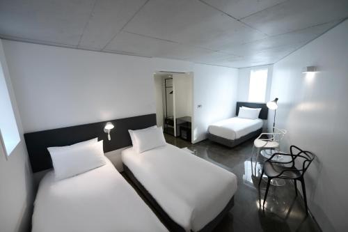 Postel nebo postele na pokoji v ubytování Creto Hotel Myeongdong