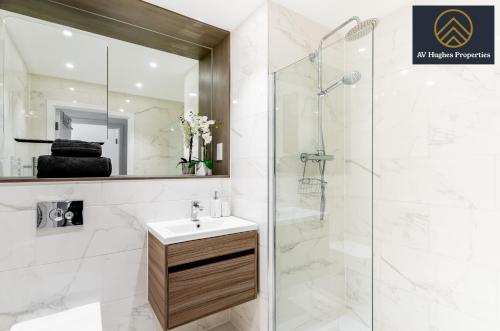 a bathroom with a sink and a shower at Exclusive Apartment by AV Hughes Properties Short Lets & Serviced Accommodation Milton Keynes with Fast Wi-Fi in Milton Keynes