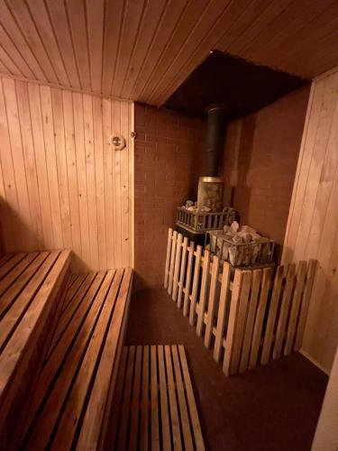a sauna with a bench and a stove in it at Спортохота in Cherkasy