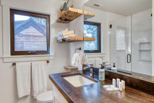 a bathroom with a sink and a toilet and a window at Lake Front Family Home at Donner in Truckee
