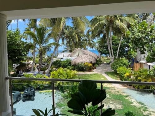 a balcony with a view of a resort with palm trees at Casa Grande Hotel Restaurant in Las Terrenas