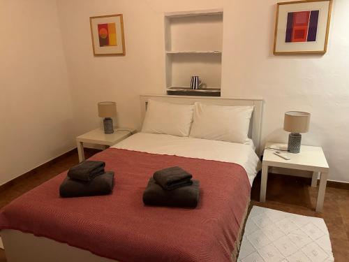 a bedroom with a bed with two towels on it at Monte de Santa Maria in Monsaraz