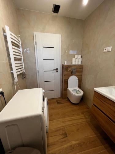 a bathroom with a bed and a toilet and a sink at Krásny apartman “Silvia” in Martin