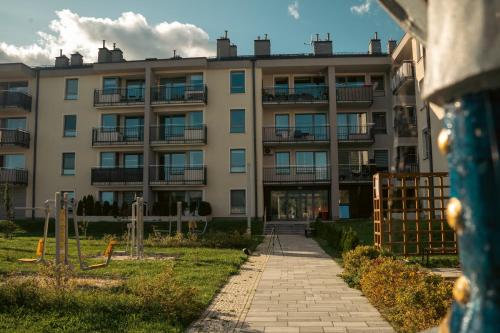 an apartment building with a pathway in front of it at Rest In Sanok Apartment in Sanok