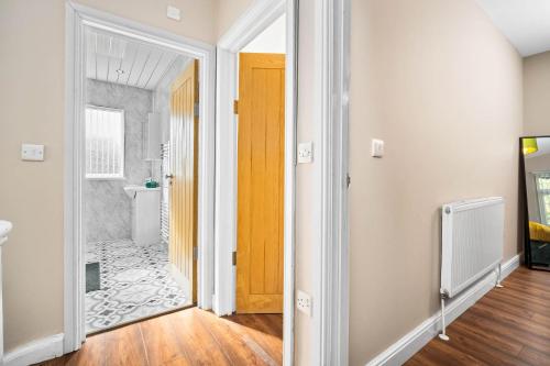 a hallway with a door leading to a bathroom at 3 bed house for Contractors & Families /Sleeps 5/Driveway parking 2 cars in Oldbury