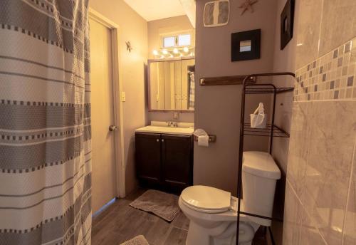 a small bathroom with a toilet and a sink at Huge Family - 5 bedroom sleeps 16 with private pool home in San Felipe