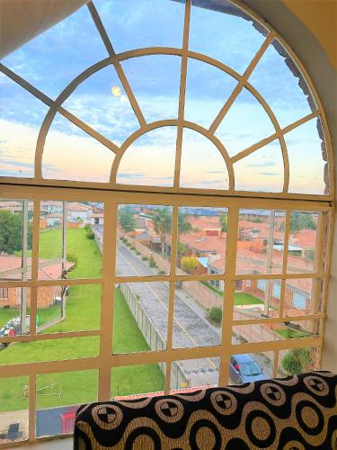 an arched window with a view of a city at Kempton Park Self Catering Private House Nearby to OR Tambo International Airport in Boksburg