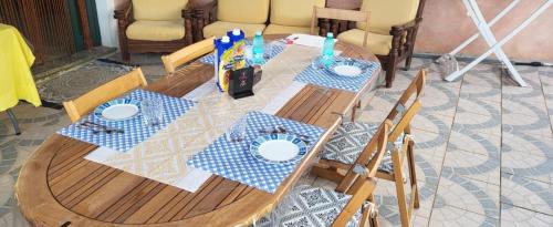a wooden table with blue and white plates on it at Villa di Cristina in Masainas