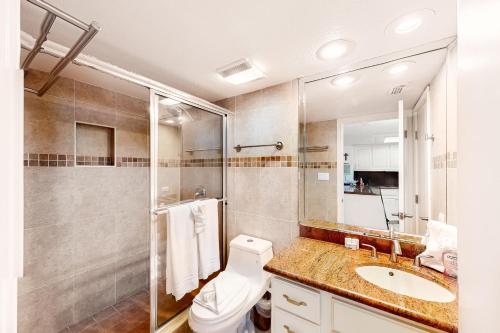 a bathroom with a toilet and a shower and a sink at Ocean Vista #102 in South Padre Island