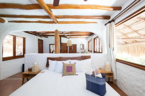 Ein Bett oder Betten in einem Zimmer der Unterkunft Las Nubes de Holbox