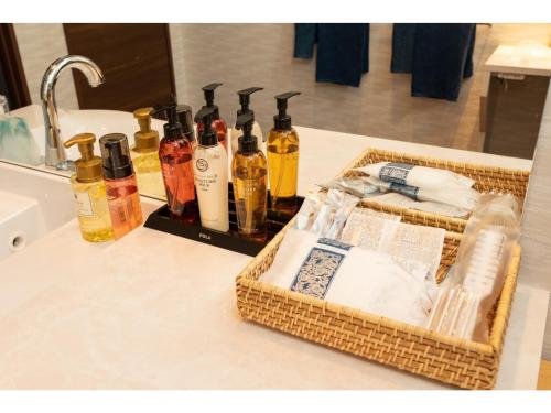 a bathroom counter with bottles of soap and towels at Kajitsu no mori - Vacation STAY 53781v in Ichinoseki