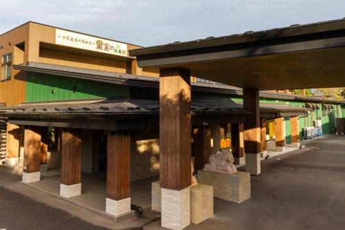 a building with wooden pillars in front of it at Kajitsu no mori - Vacation STAY 53781v in Ichinoseki