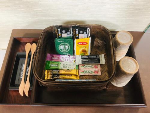 a basket on a table with packets and utensils at Kajitsu no mori - Vacation STAY 53766v in Ichinoseki