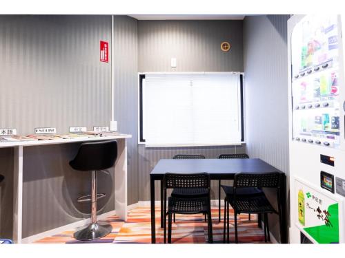 a dining room with a table and chairs at ＨＯＴＥＬ ＰＡＧＯＤＡ - Vacation STAY 65048v in Nara