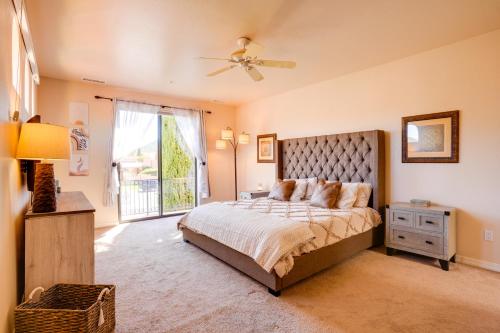 a bedroom with a bed and a ceiling fan at Sedona Getaway with Sunlit Patio Near Bell Rock! in Sedona