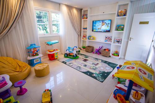 a childs room with many toys and a tv at Villa do Vale Boutique Hotel in Blumenau