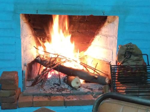 a fire in a brick oven with flames at La Griselda in El Mollar