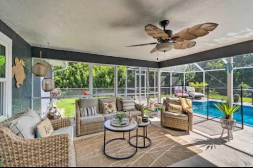 a living room filled with furniture and a ceiling fan at Luxury modern home Heated pool best Location in Port Charlotte