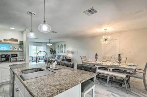 a kitchen and living room with a sink and a table at Luxury modern home Heated pool best Location in Port Charlotte