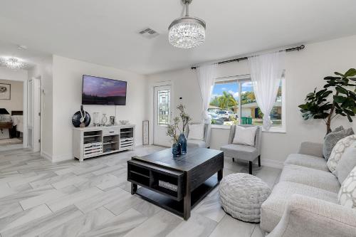 a living room with a couch and a table at Luxury modern home Heated pool best Location in Port Charlotte