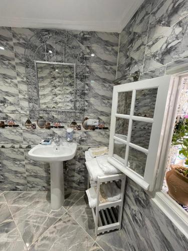 a bathroom with a sink and a window at Charming Cozy house kasbah in Tangier