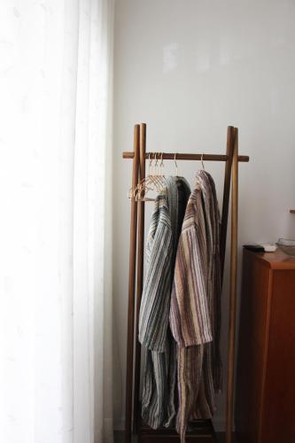 a towel rack with three towels hanging on it at ARRUDA GARDEN LUXURY APARTMENT with AC in Cascais