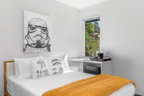 a bedroom with a bed with a helmet picture on the wall at Luke's Jedi Meditation Chamber in Seattle