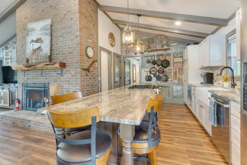 a kitchen with a large counter and a fireplace at Lakefront Hayesville Retreat with Private Swim Dock in Hayesville