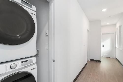 a kitchen with a washer and dryer in a room at Luke's Jedi Meditation Chamber in Seattle