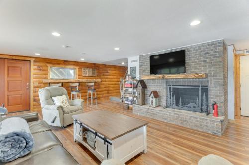 a living room with a fireplace and a tv at Lakefront Hayesville Retreat with Private Swim Dock in Hayesville
