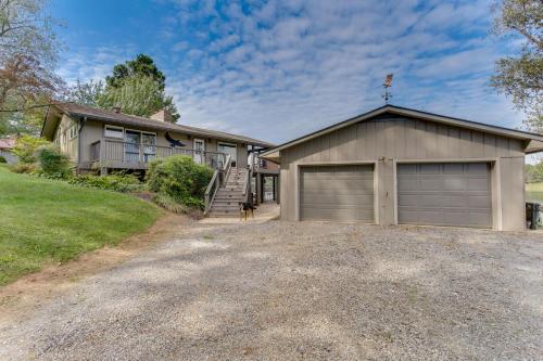 a large house with a garage and a driveway at Lakefront Hayesville Retreat with Private Swim Dock in Hayesville