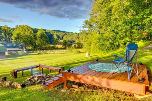 a deck with a hot tub and a chair on it at Hendersonville Cabin Near Hiking and Waterfalls! in Hendersonville