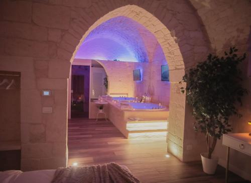 a bathroom with an archway with a tub and a sink at Romantic Suite with Private Jacuzzi Malely Suite in Martina Franca