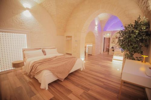 a bedroom with a large bed in a room at Romantic Suite with Private Jacuzzi Malely Suite in Martina Franca