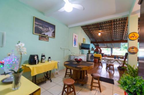 a living room with a table and some chairs at HOSTEL DIKASA in Cuiabá