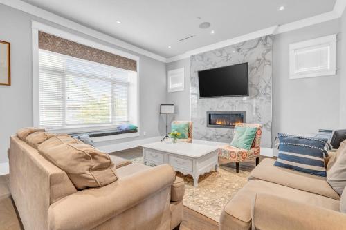 a living room with two couches and a fireplace at Vancouver West Cozy Retreat by Host Launch in Vancouver