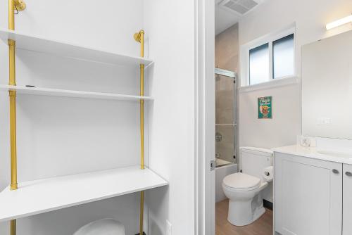a bathroom with a toilet and a sink at Yoda's Swamp Suite in Seattle