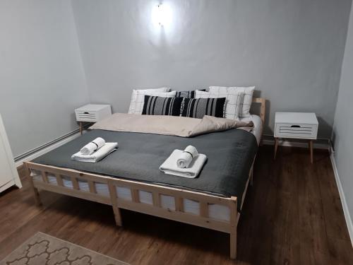 a bedroom with a bed with two towels on it at Grey House in Braşov