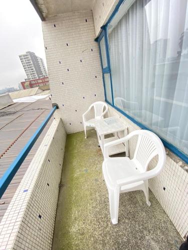 two white chairs and a table on a roof at NEW HOTEL CRUZ DEL SUR in Concepción