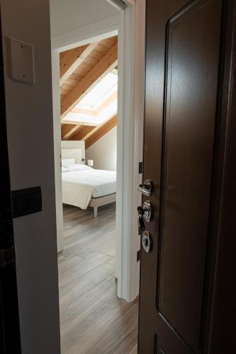 a door leading into a bedroom with a bed at Affittacamere Bar Leo in Pregnana Milanese