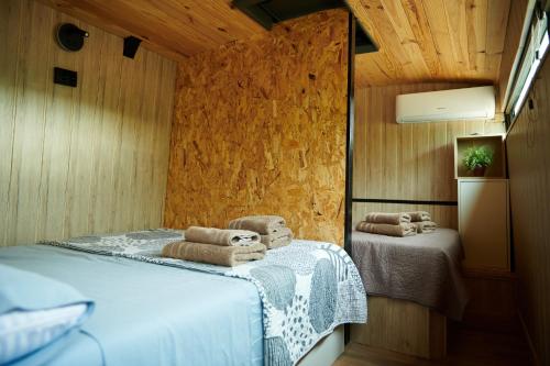 a bedroom with two beds with towels on them at cuchibus in Madrid