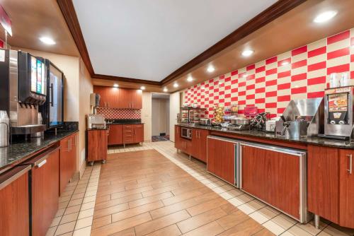 a large kitchen with wooden cabinets and appliances at Best Western Plus White Bear Country Inn in White Bear Lake
