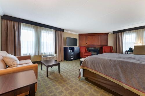a hotel room with a bed and a couch at Best Western Plus White Bear Country Inn in White Bear Lake