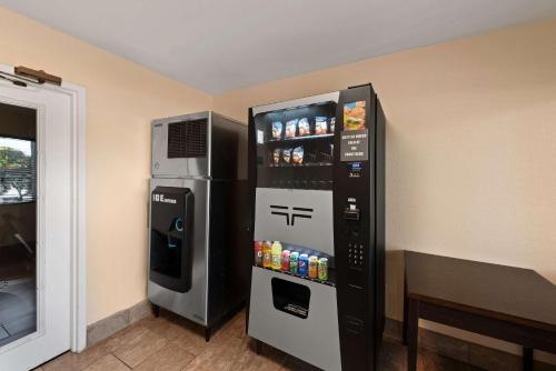 a refrigerator and a drink dispenser in a room at Best Western Executive Inn in Grove City
