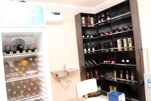 a refrigerator filled with lots of bottles of wine at Gregory University Guest House in Lagos