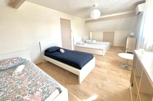 a room with two beds and a sink in it at VILLA EDOUARD - 180m2 in nature & forest - 20min Disney - 7min airport in Claye-Souilly