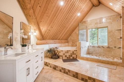 a large bathroom with a tub and a sink at Sagle Sunrise in Sagle